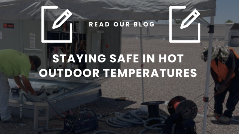 HVAC technicians working under shade during rooftop service in hot outdoor temperatures