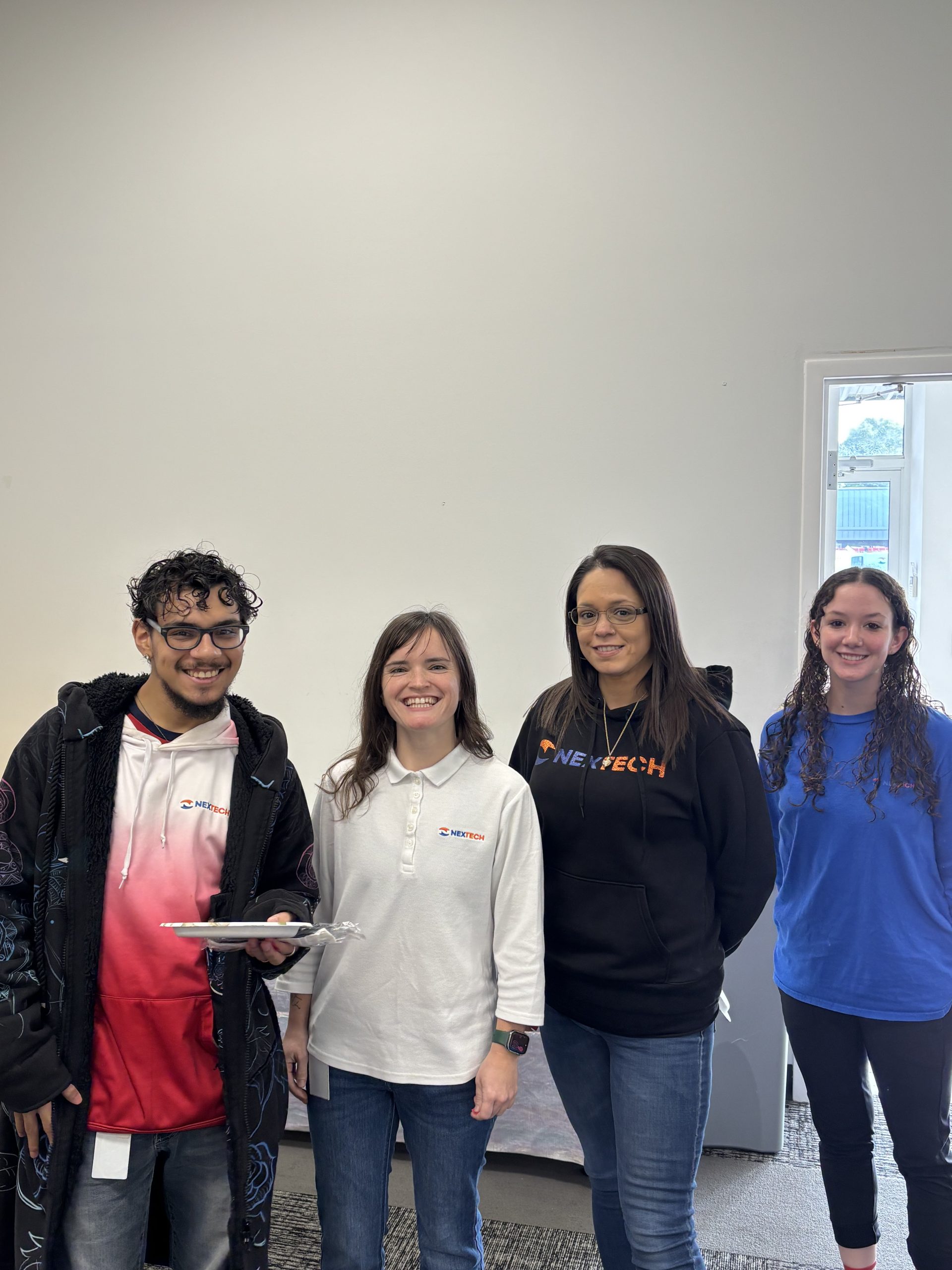 The image features a young person standing confidently with a smile, dressed in casual denim attire. This reflects NexTech's approachable and friendly brand image, emphasizing the importance of customer service and teamwork in the HVAC industry.