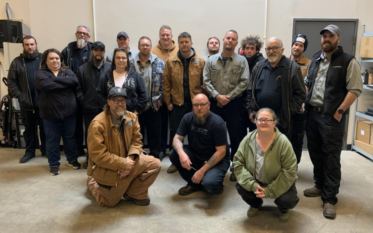 The image features a group of individuals standing together outdoors, showcasing a sense of camaraderie and teamwork. This reflects NexTech's commitment to building strong relationships within the HVAC community and engaging with clients and partners.