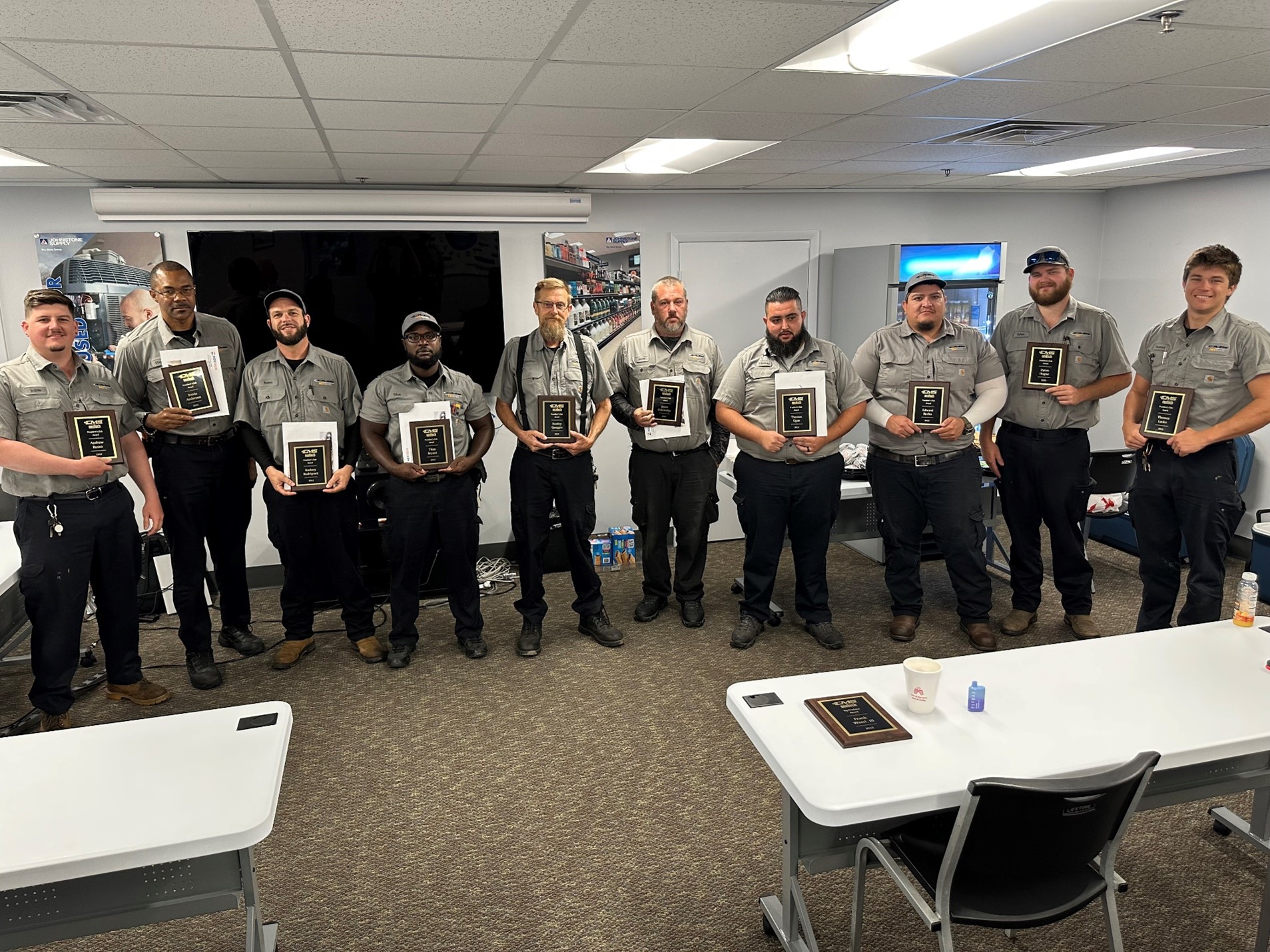 The image depicts a professional office environment with a desk setup, suggesting a collaborative workspace. This setting is relevant to NexTech as it highlights the importance of teamwork and organization in delivering HVAC services.