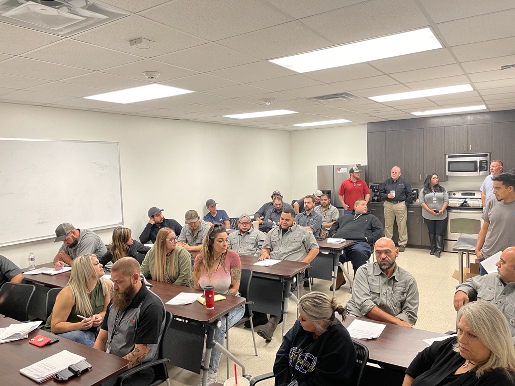 The image depicts a classroom setting with furniture including chairs and tables, suggesting a space designed for collaboration and learning. This environment highlights the importance of comfortable and efficient HVAC solutions, which are essential for maintaining a conducive atmosphere for both educational and business meetings.